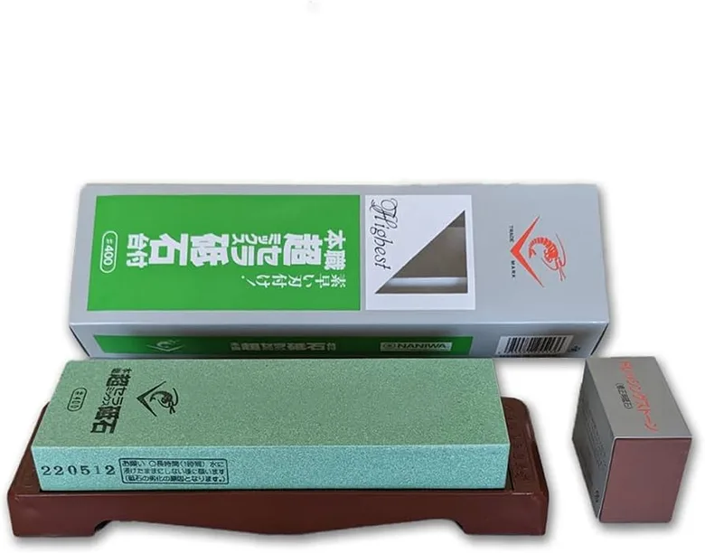 Green Naniwa SS400 stone on its brown stand, a small dressing stone beside it, Japanese box behind.